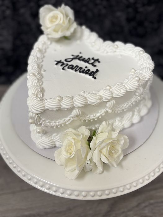 White heart-shaped Just Married cake with pearls and roses