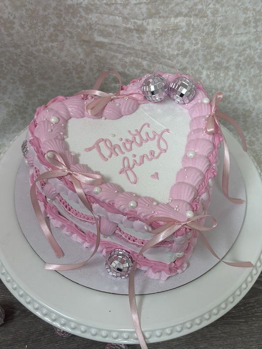 Pink vintage heart cake with bows and disco balls reading Thirty Fine