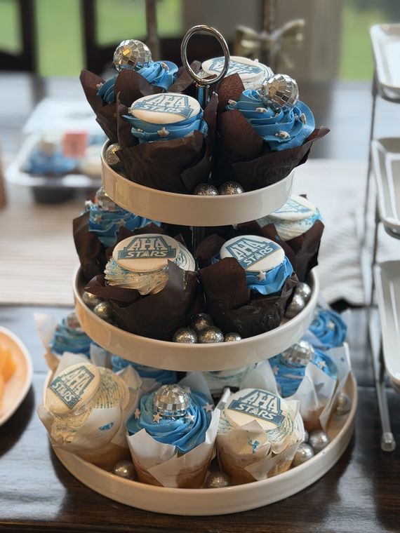 Three-tier tower of blue and silver AHA Stars cupcakes with disco balls